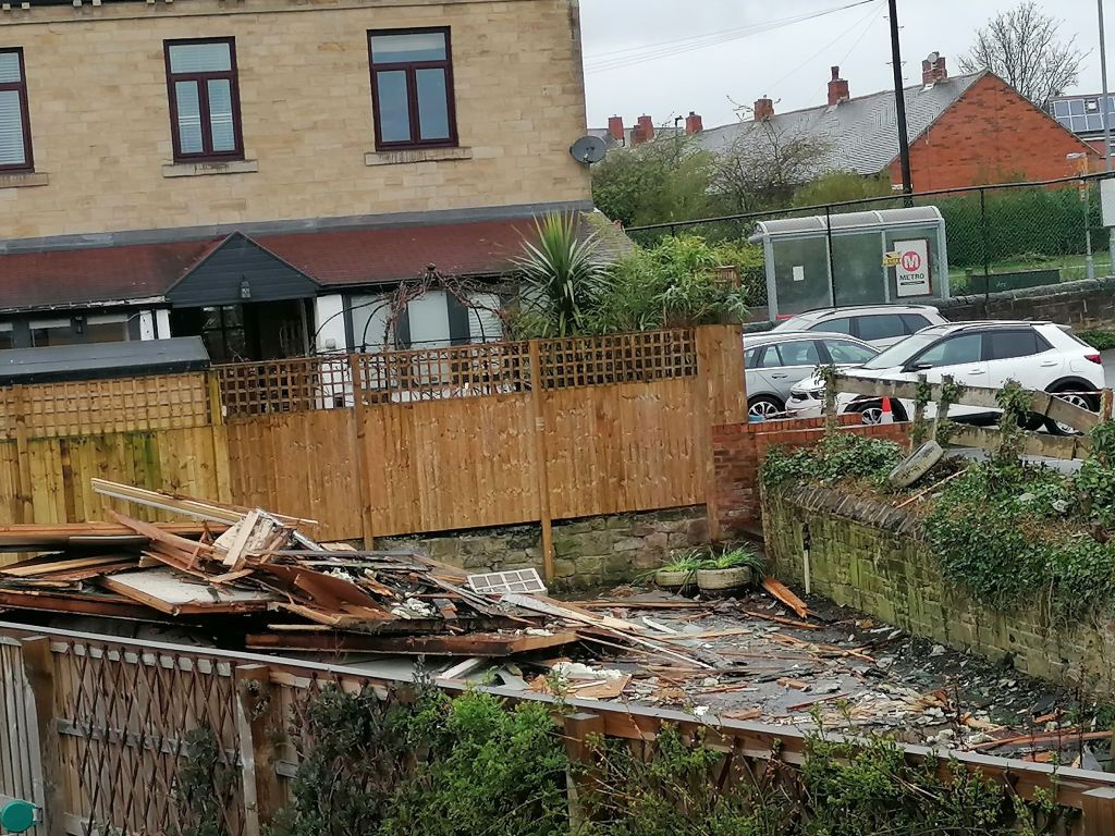 Cleared site with piles of wood.